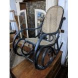 An early 20th century black lacquered bentwood rocking chair Location: G