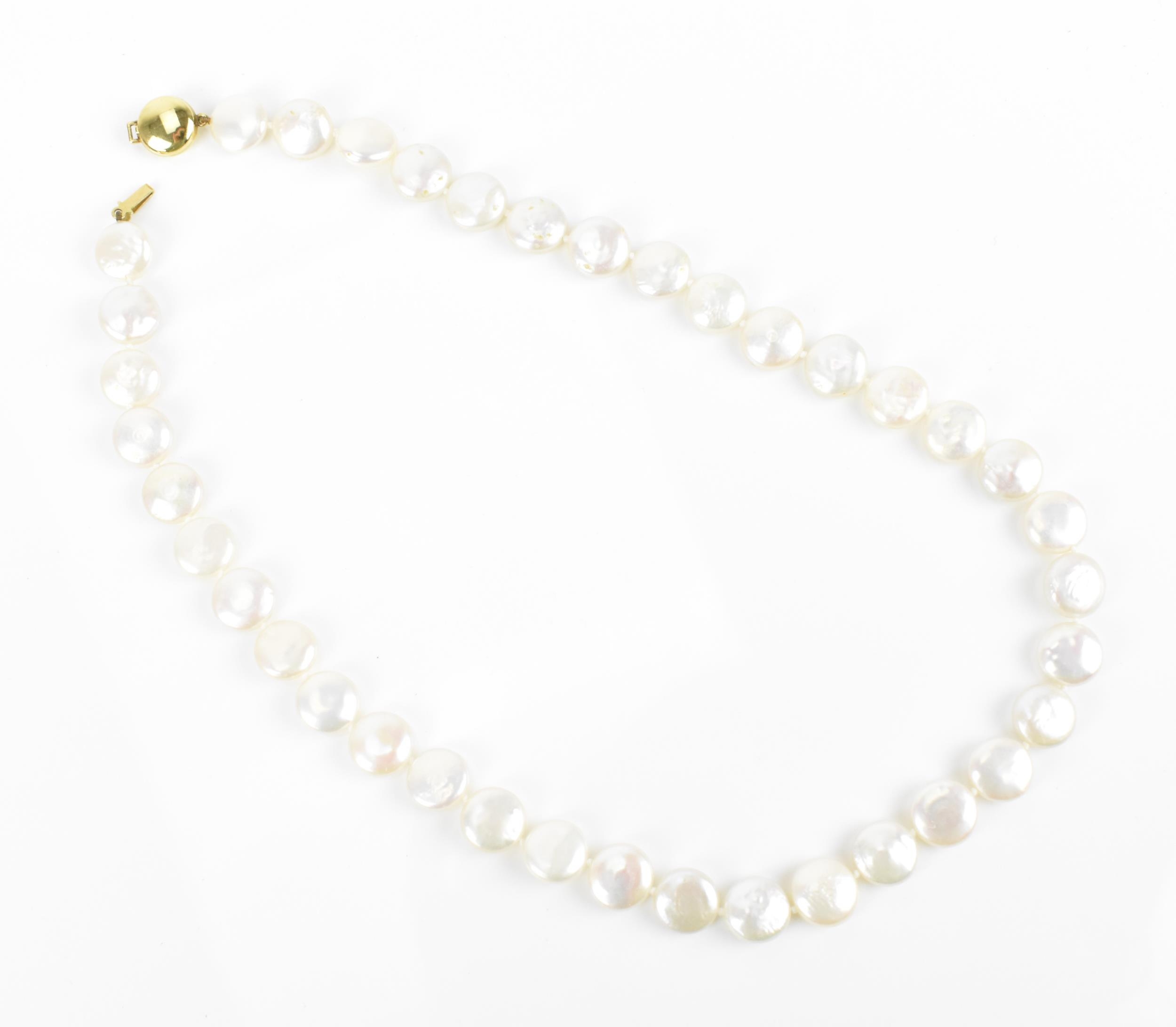 A single strand flat coin pearl necklace with 9ct yellow gold catch clasp, 45 cm long, the catch