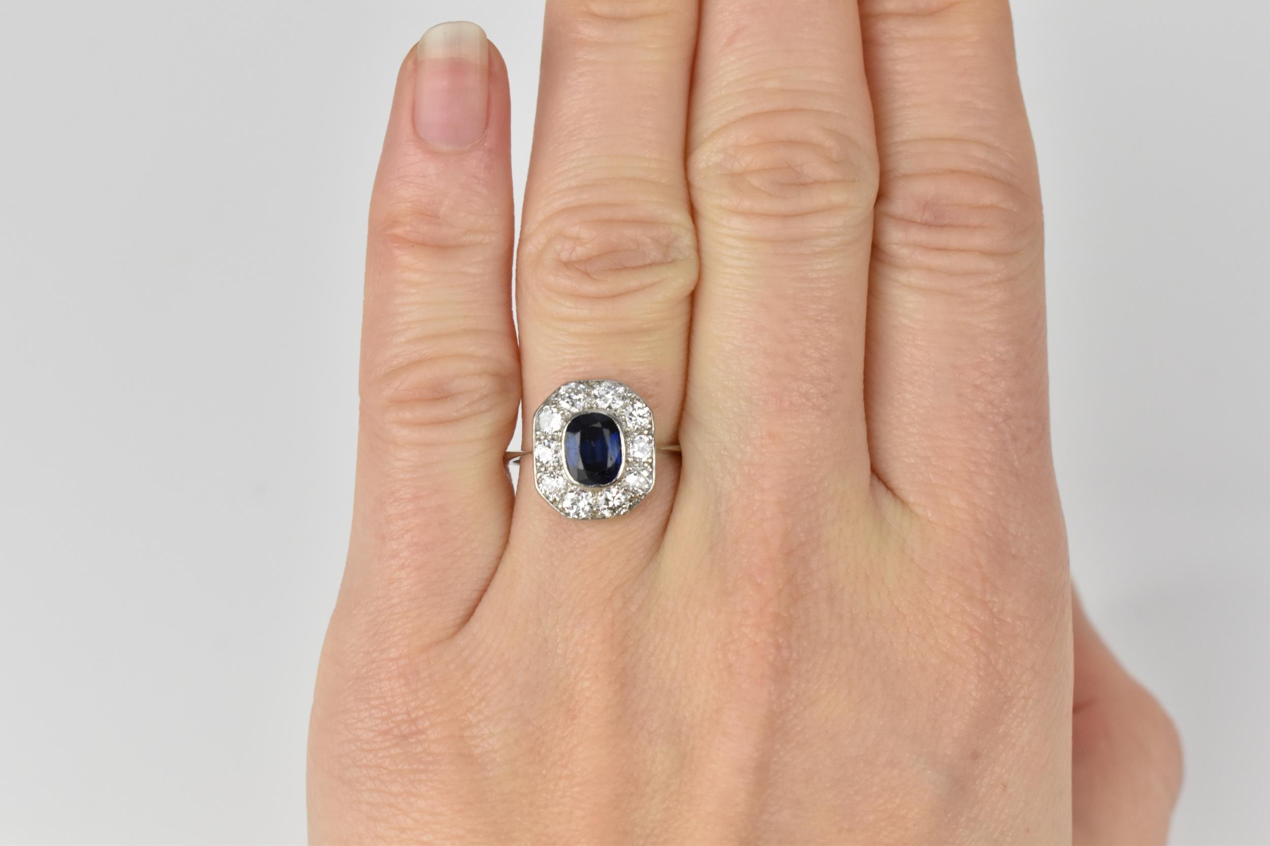 An Art Deco platinum, diamond and sapphire dress ring, the central deep blue sapphire in a - Image 6 of 6