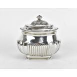 An Edwardian silver tea caddy by Charles Stuart Harris, London 1902, with gadrooned rim, fluted