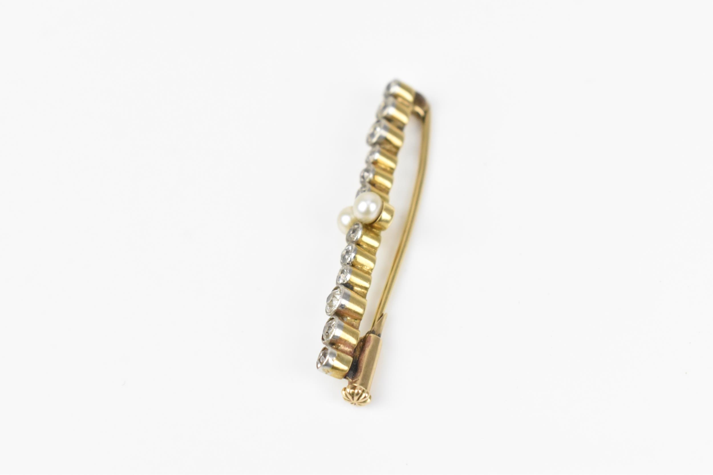 A yellow and white metal, diamond and pearl bar brooch, designed with twelve various sized rub- - Image 2 of 5