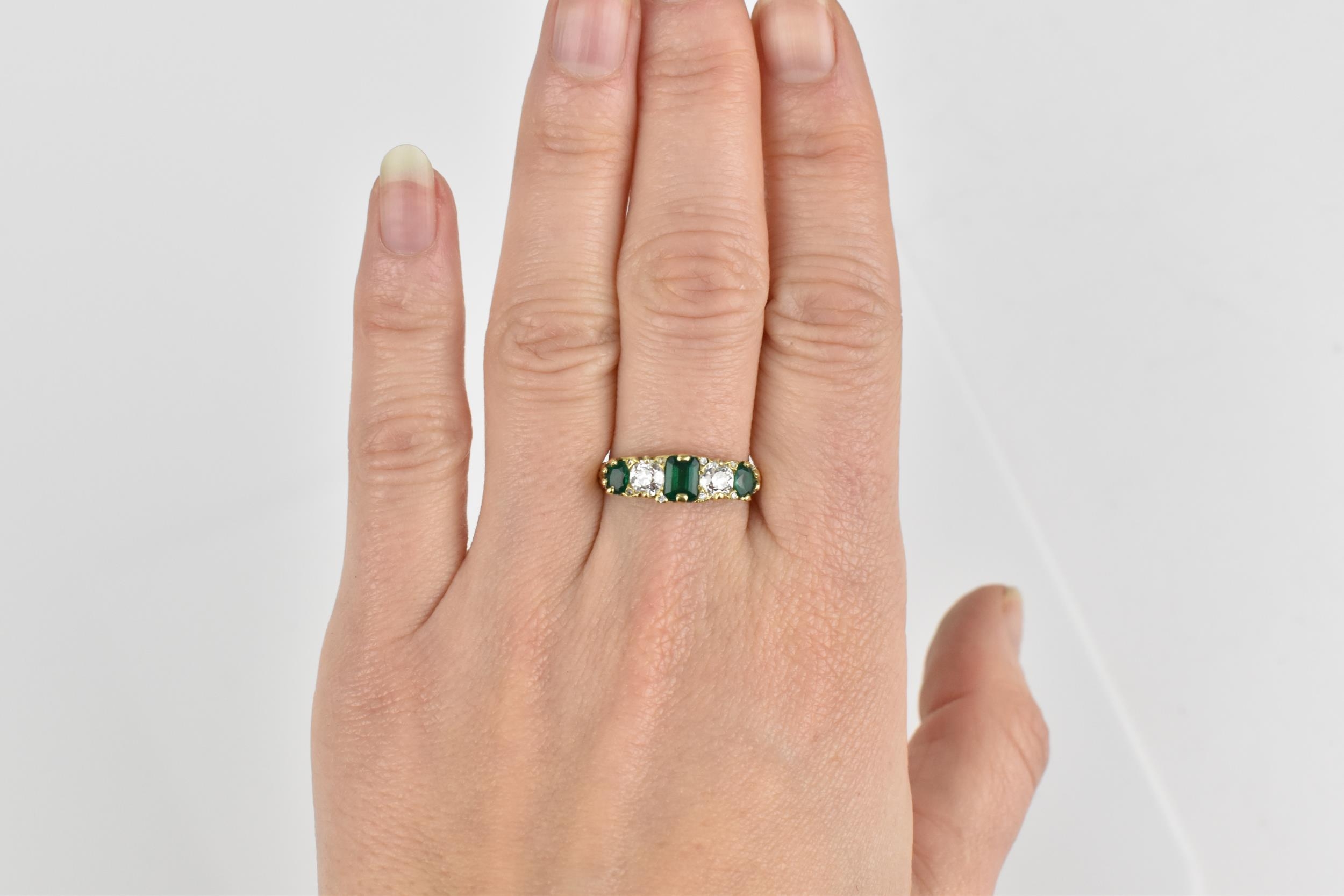 A yellow metal, diamond and emerald five stone ring, set with central octagon cut emerald flanked - Image 6 of 6