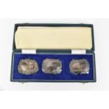A cased set of three Elizabeth II silver wine labels by C J Vander Ltd, comprising one for Whisky,