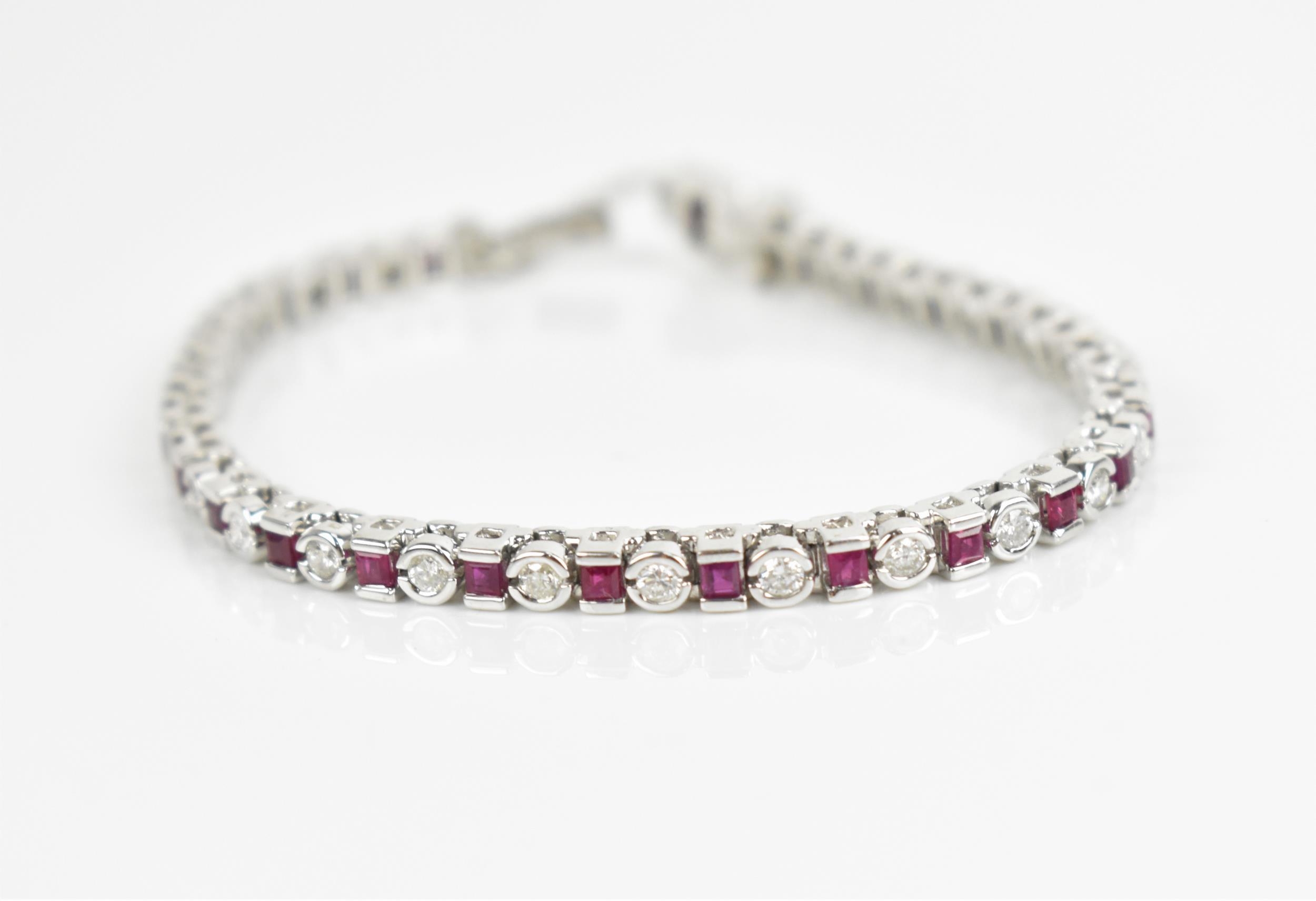 An 18ct white gold, diamond and ruby bracelet, with alternating round brilliant cut diamond and - Image 2 of 8