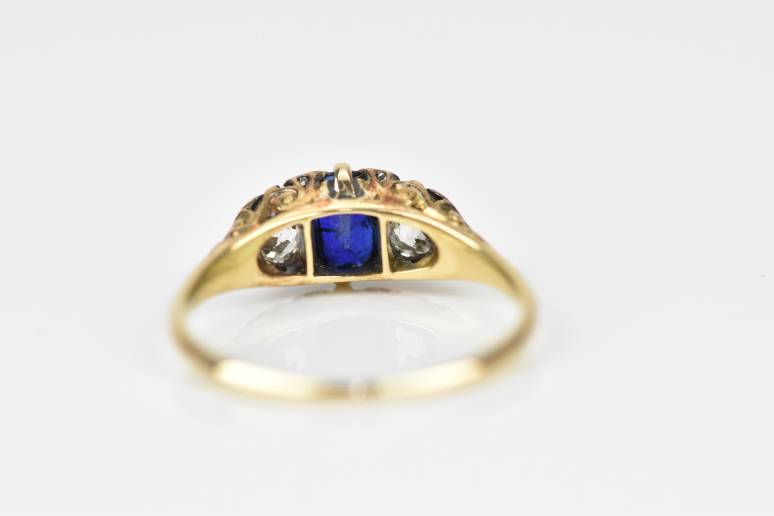 A yellow metal, blue sapphire and diamond dress ring, with central octagon cut sapphire flanked with - Image 5 of 6