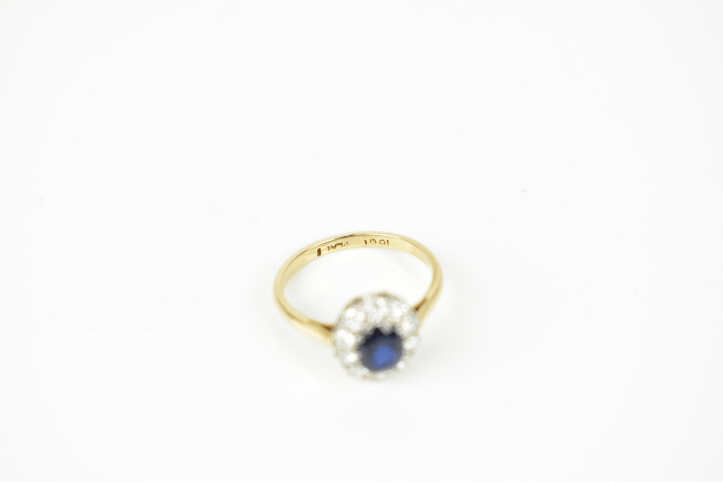An 18ct yellow gold, sapphire and diamond cluster ring, with central oval cut blue sapphire in a - Image 6 of 6