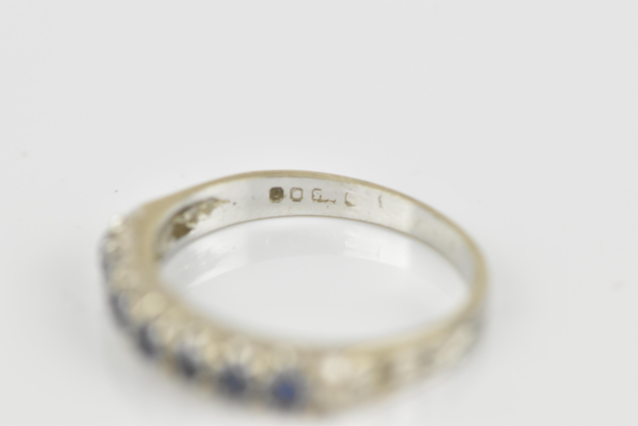 A 9ct white gold and blue sapphire half eternity ring, set with a row of seven same-sized pave-set - Image 6 of 7