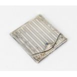 A Continental Art Deco silver match book holder, of square form, mounted with a single blue cabochon