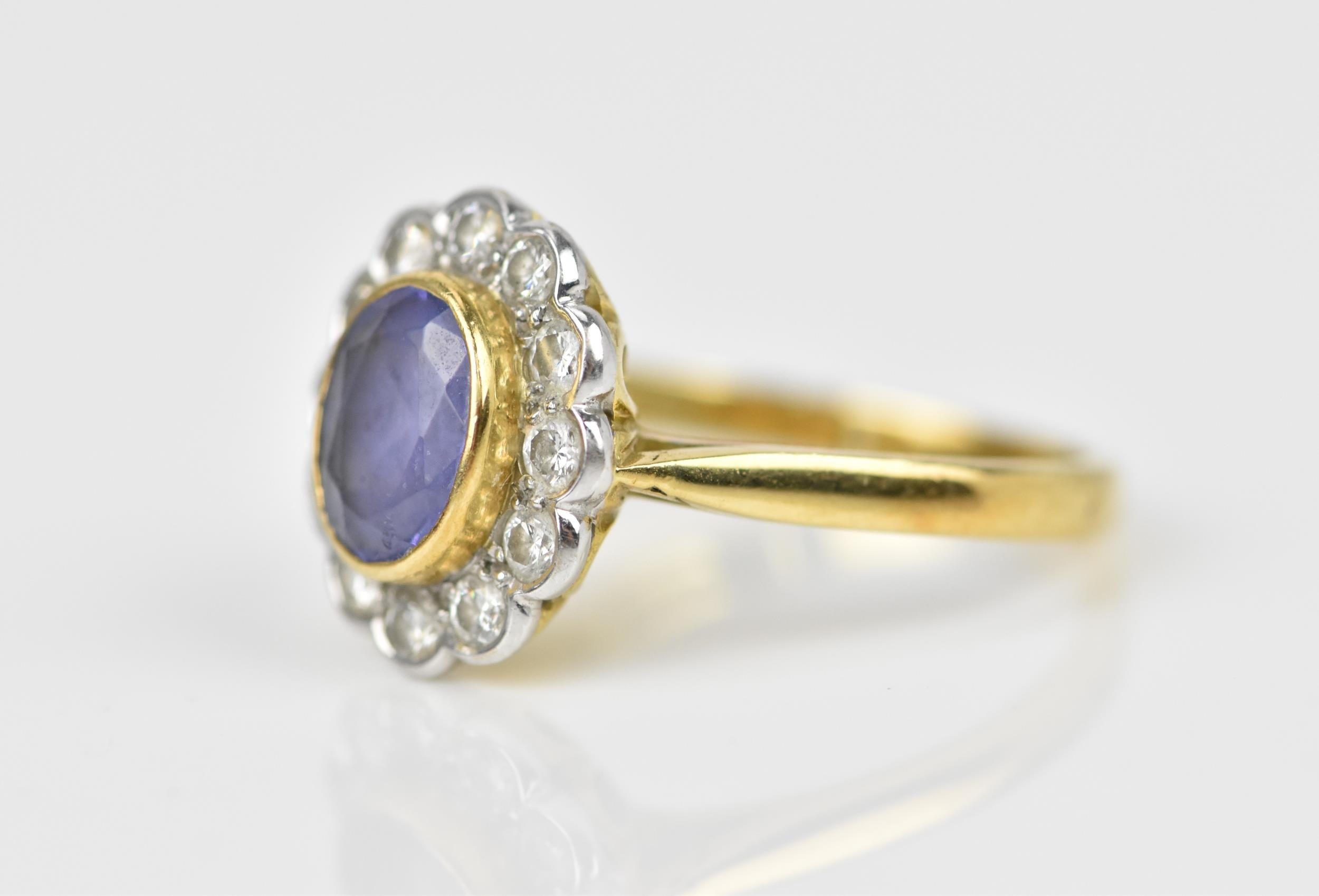 An 18ct yellow gold, white metal, pale blue stone and diamond halo dress ring, the central oval - Image 2 of 4