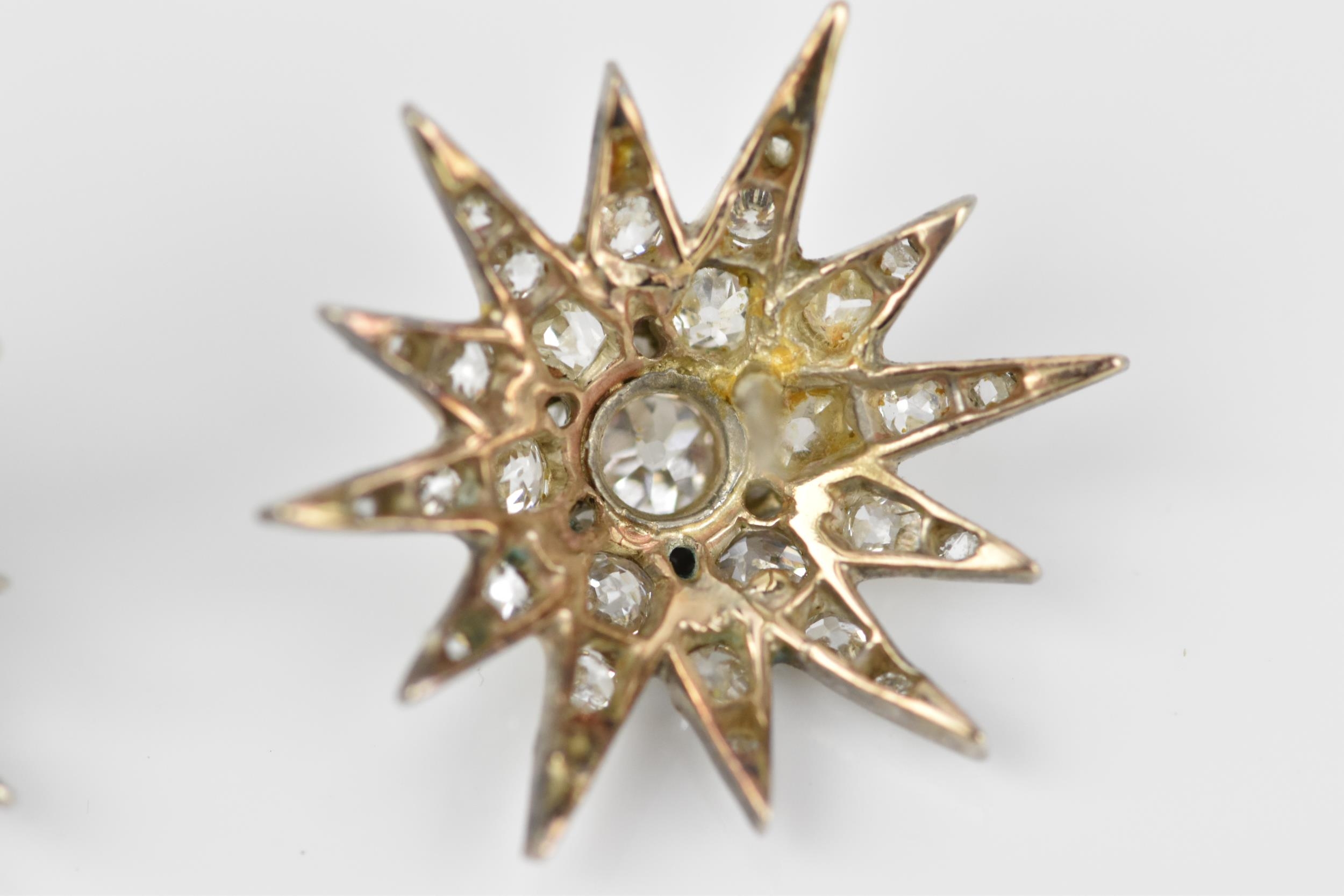 A pair of early 20th century white metal and diamond starburst earrings, set with old mine cut - Image 9 of 9