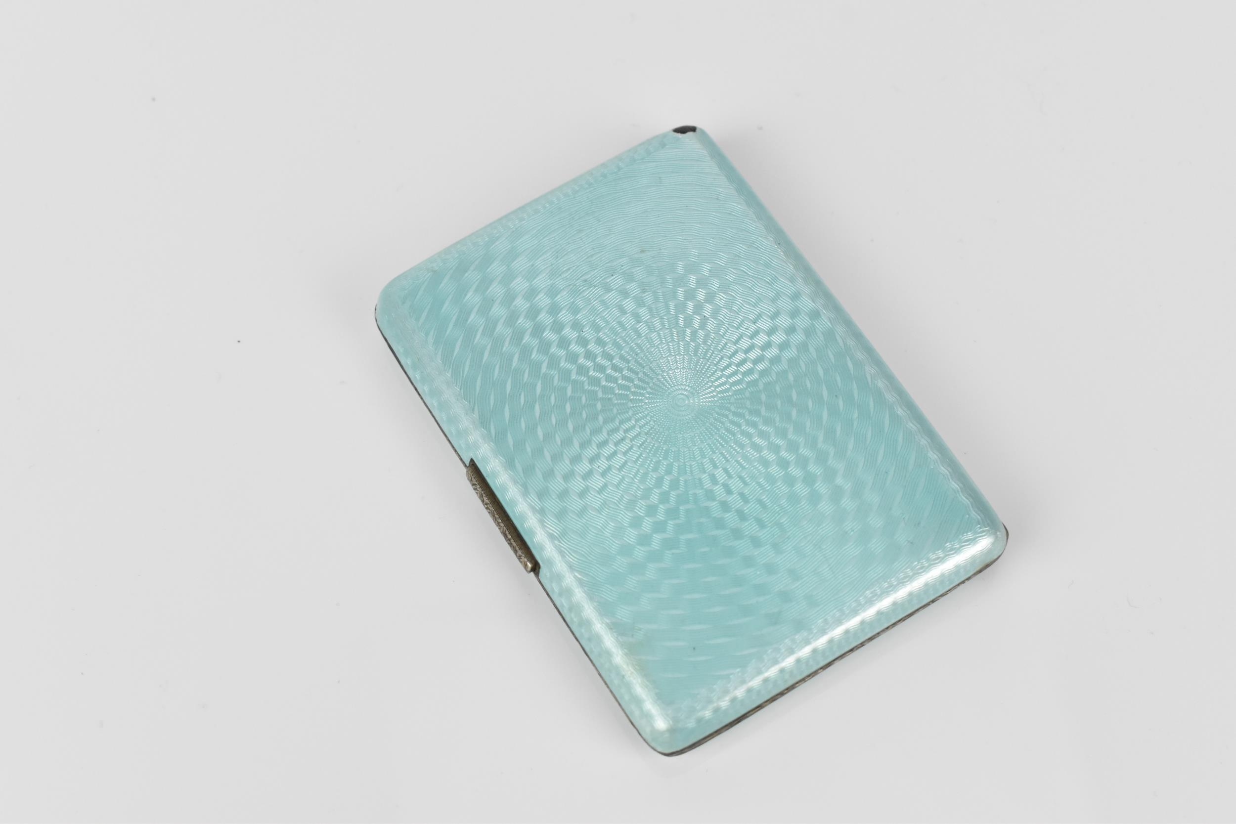 An Art Deco enamelled silver cigarette case, the exterior with engine turned ice blue enamel, with - Image 2 of 7