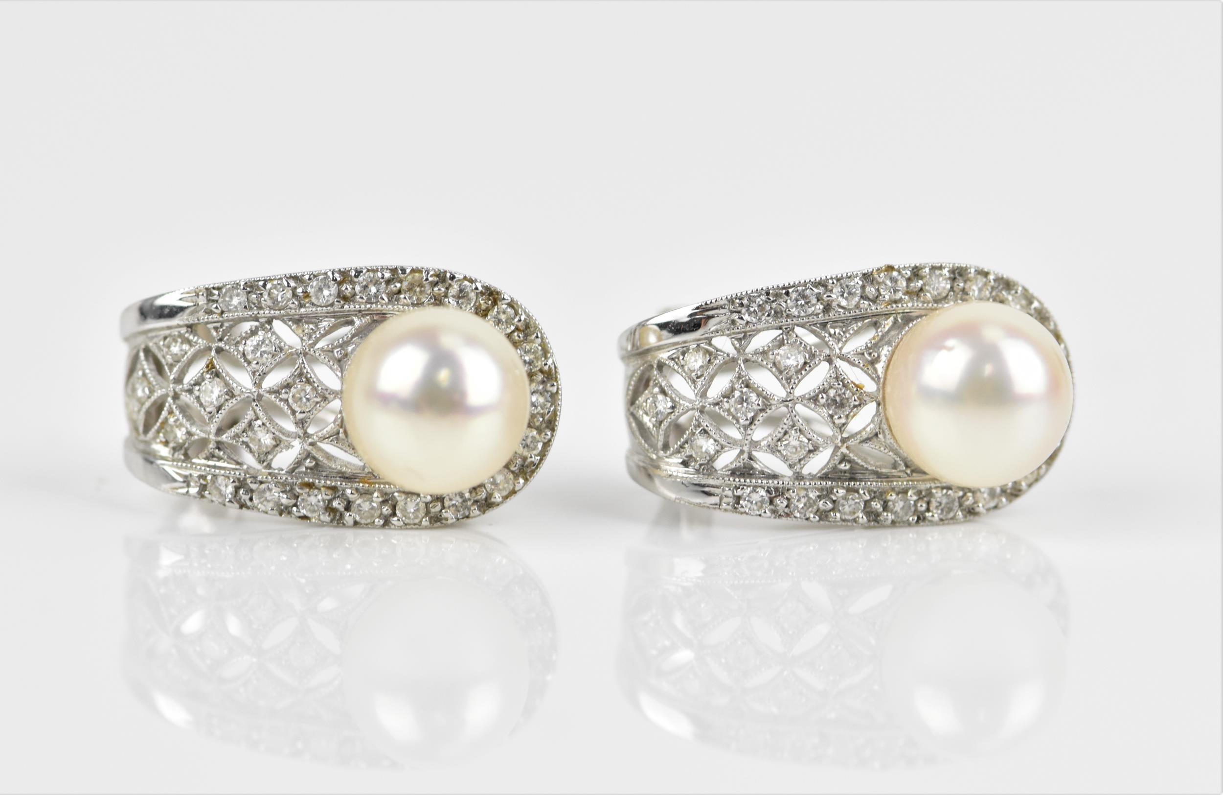 A pair of 18ct white gold, diamond and pearl earrings, of pierced lattice design, each inset with