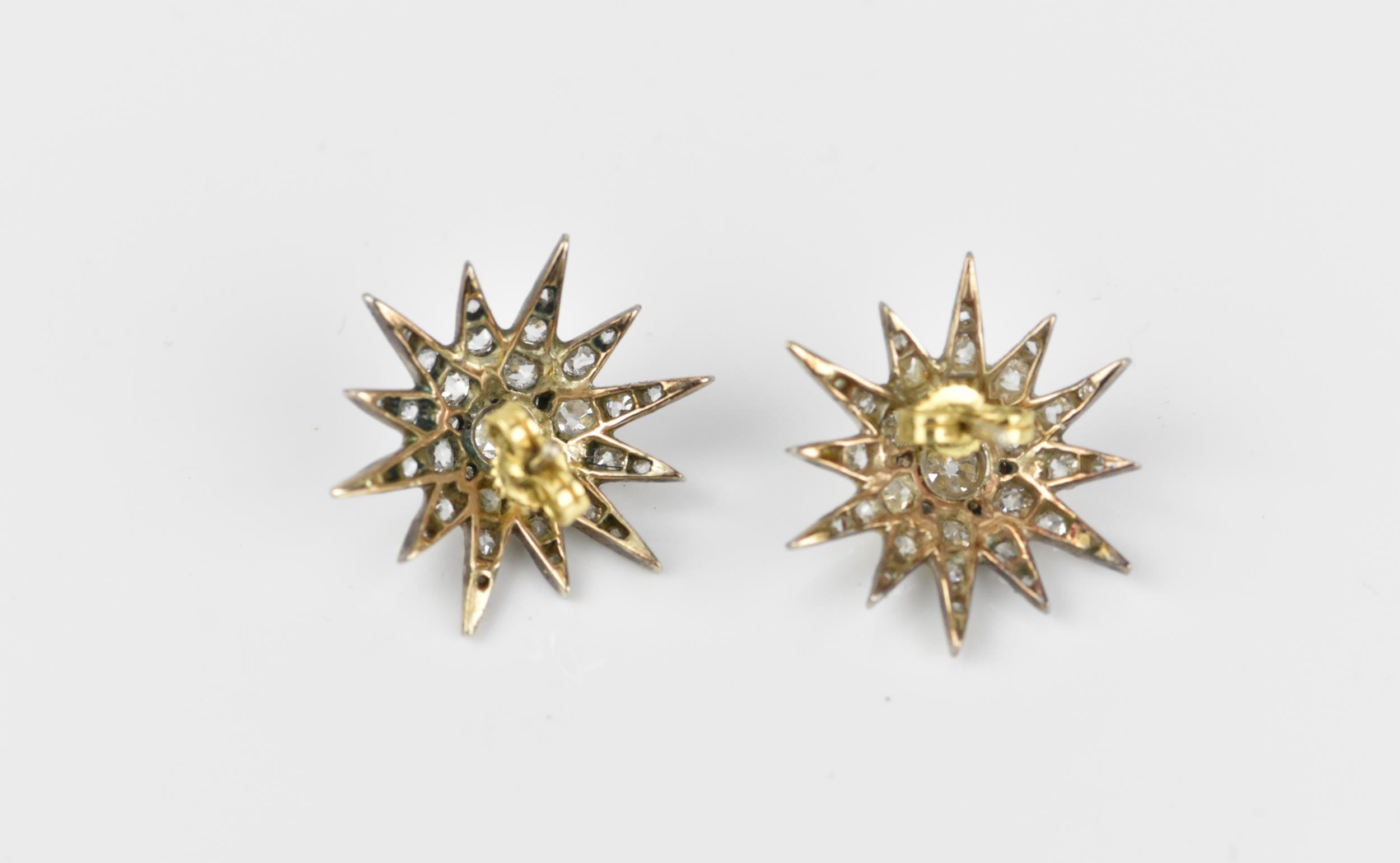 A pair of early 20th century white metal and diamond starburst earrings, set with old mine cut - Image 7 of 9