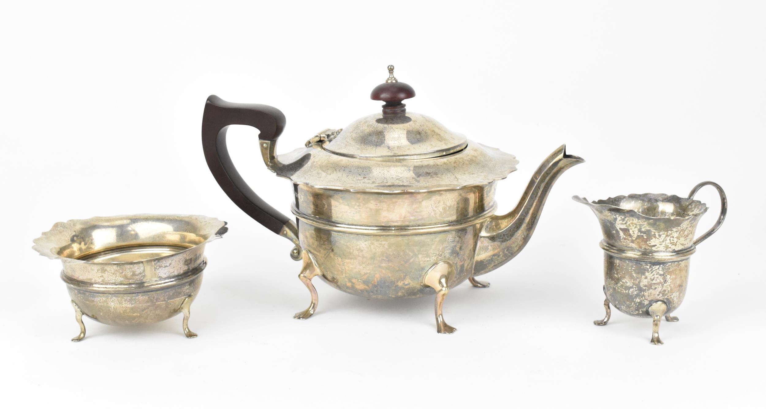 A George V silver three-piece tea set by Robert William Jay, Birmingham 1932, comprising a teapot,