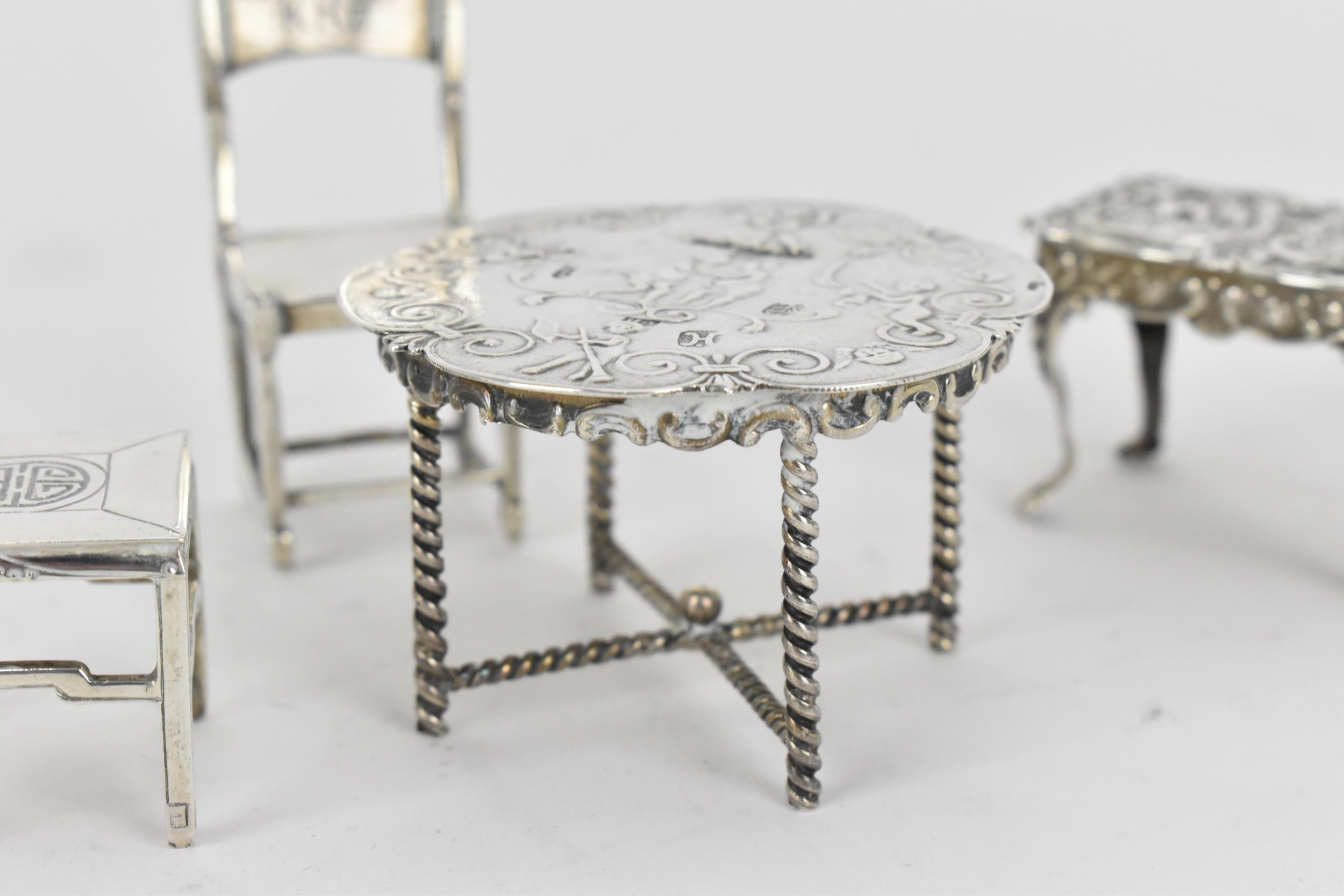A small collection of silver and white metal miniature doll house furniture, to include a silver - Image 3 of 8