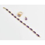 A 9ct yellow gold and amethyst bracelet, the stones in spectacle setting, linked with hoops and