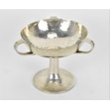 An Edwardian Art Nouveau silver hammered bowl on stand by William Hutton & Sons, London 1906, with
