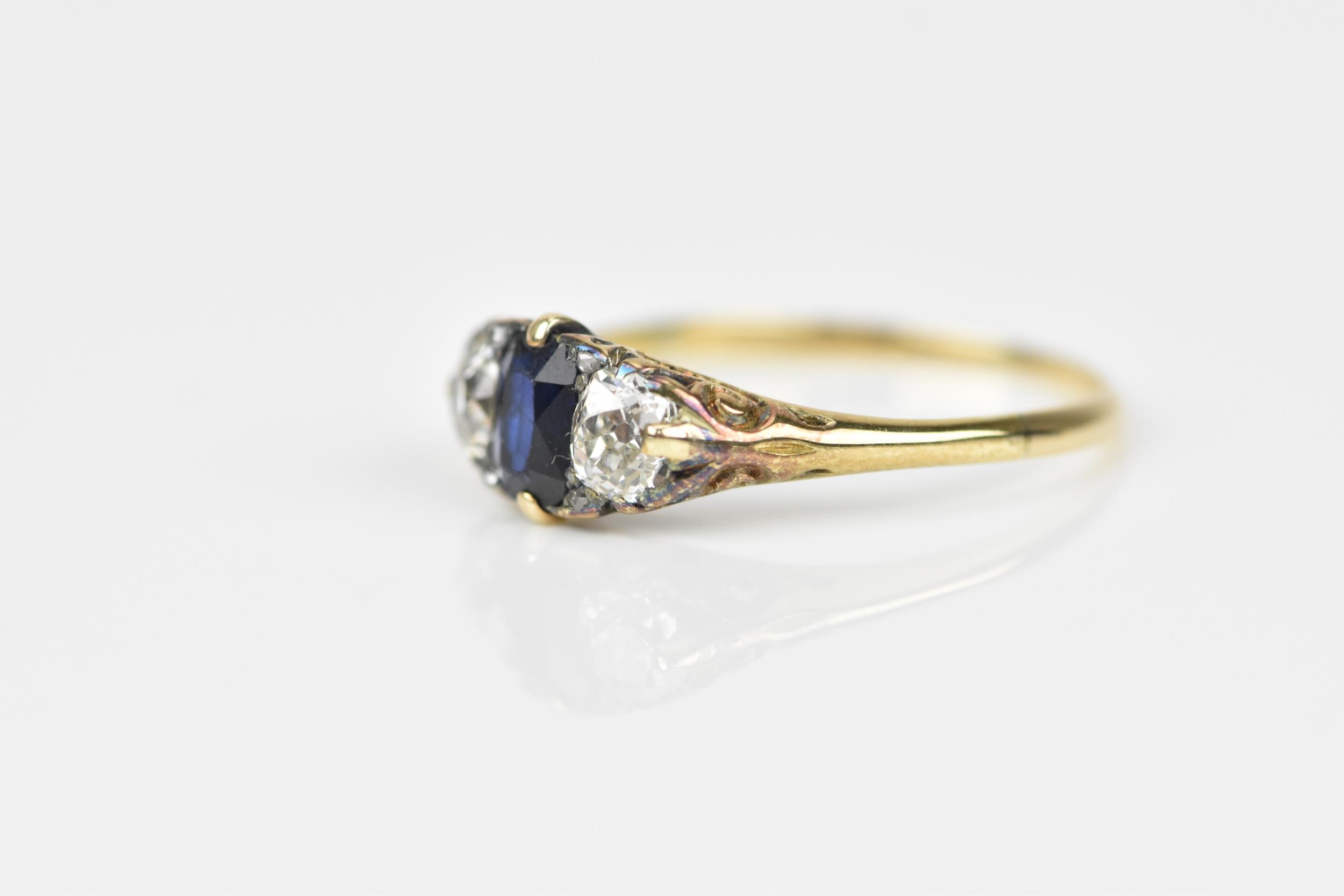A yellow metal, blue sapphire and diamond dress ring, with central octagon cut sapphire flanked with - Image 4 of 6