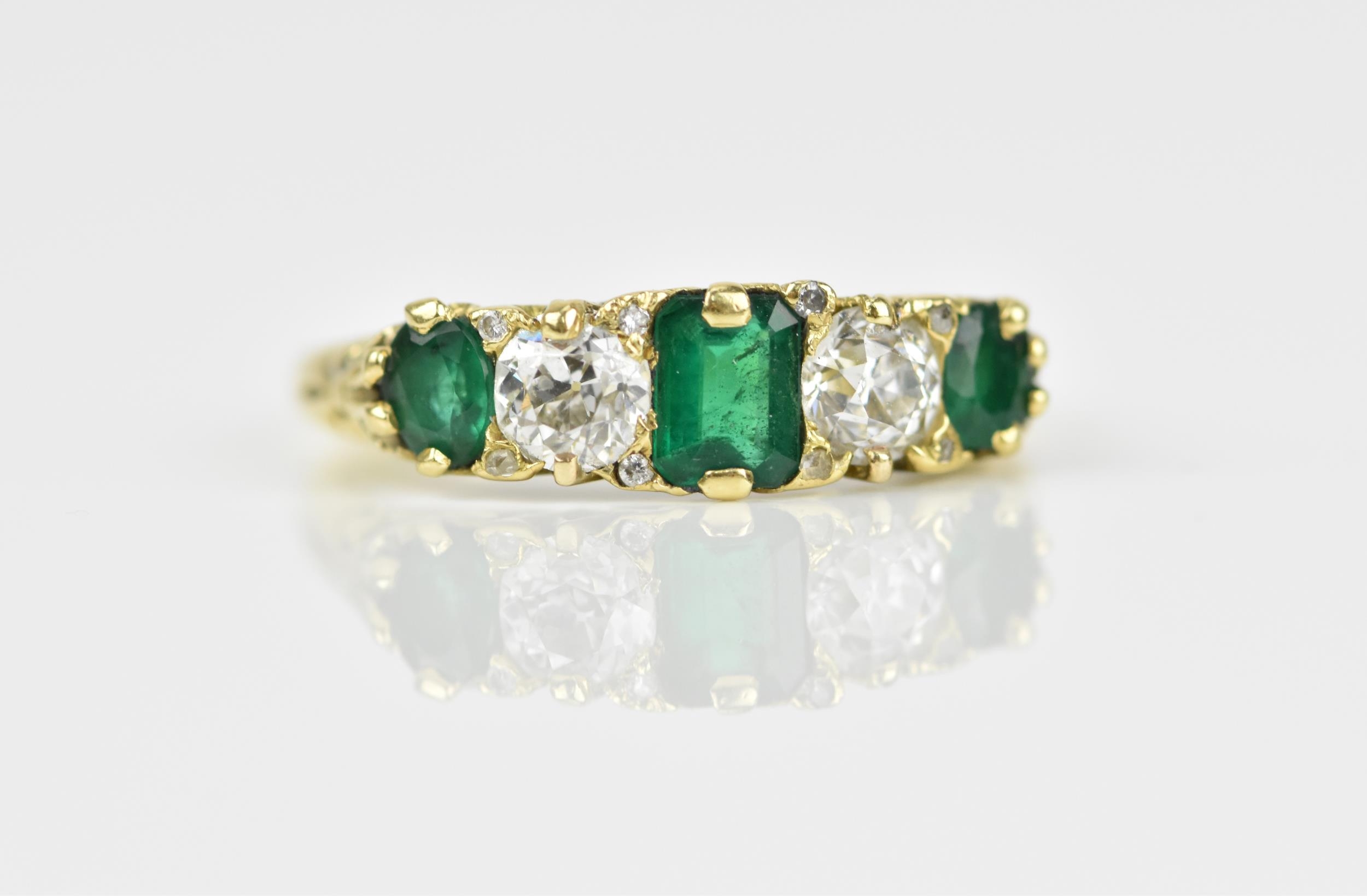 A yellow metal, diamond and emerald five stone ring, set with central octagon cut emerald flanked - Image 3 of 6