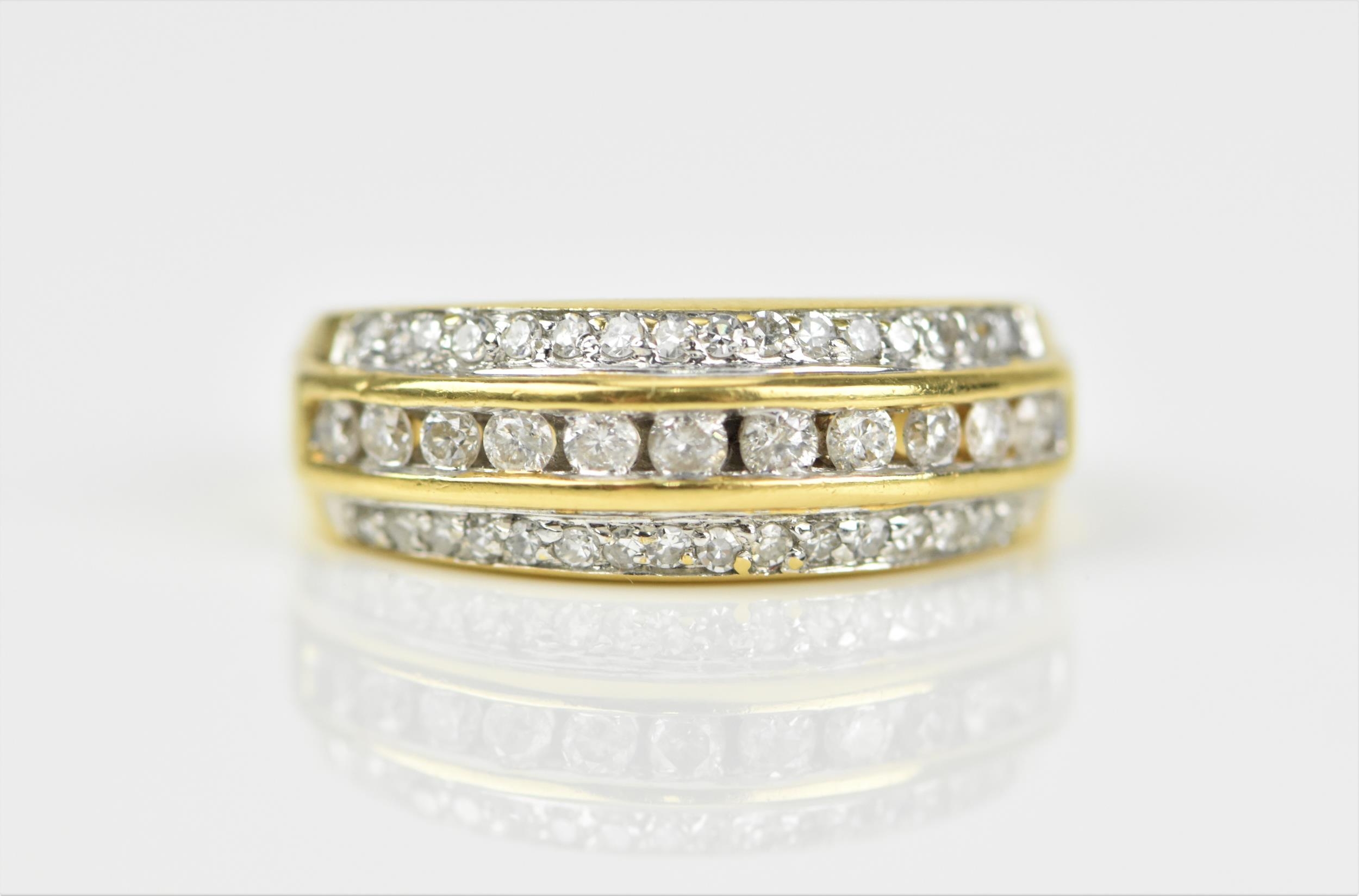 An 18ct yellow gold and diamond three row ring, set with a central row of brilliant cut channel - Image 5 of 5