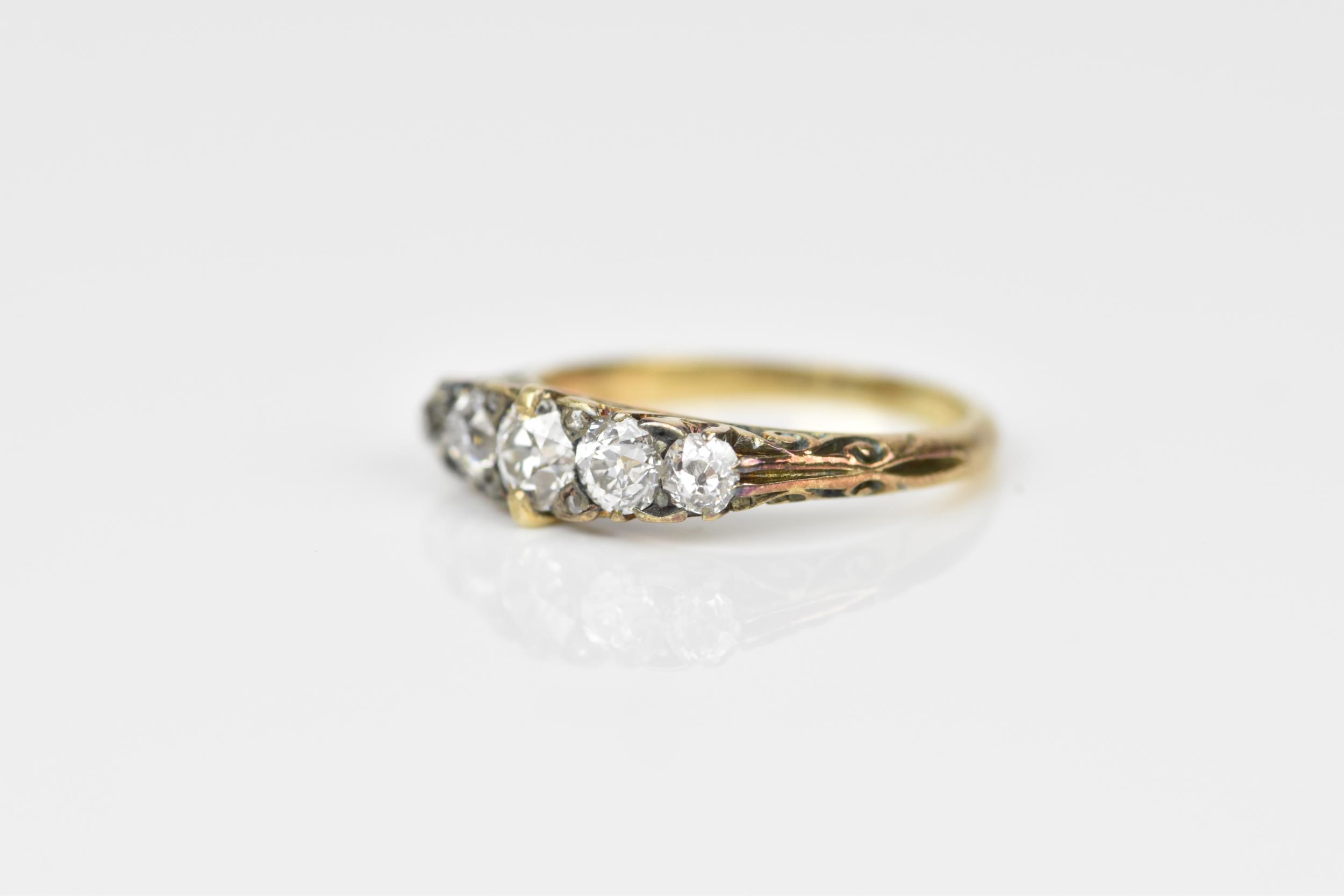 A yellow metal and five stone diamond ring, set with graduated old European cut stones, the - Image 2 of 6