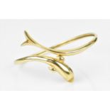 A yellow metal dolphin bangle, 6.2 cm wide, weight 11.6 grams