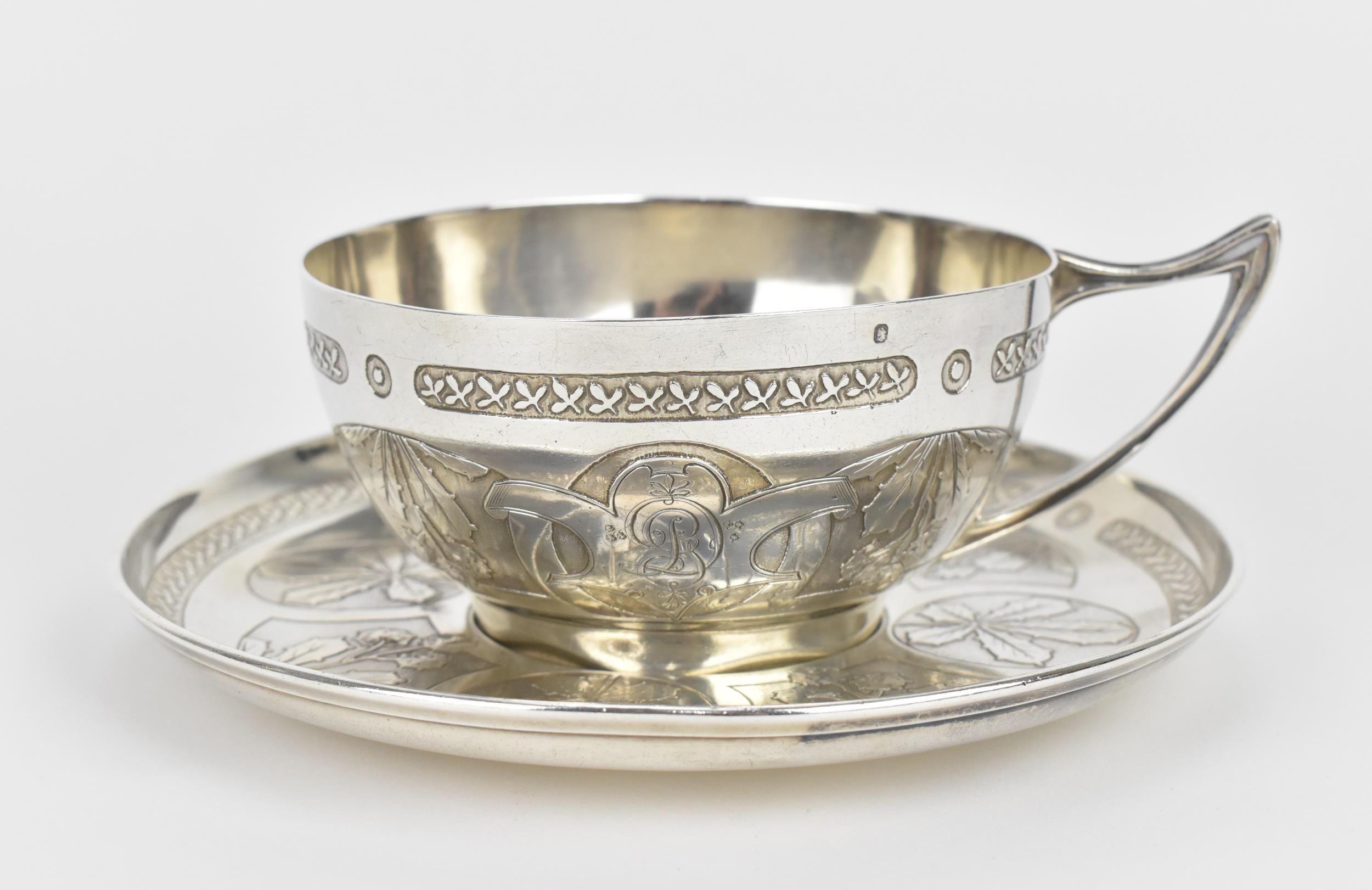 A French silver cup and saucer by the Tetard brothers, circa 1900, with horticultural theme frieze