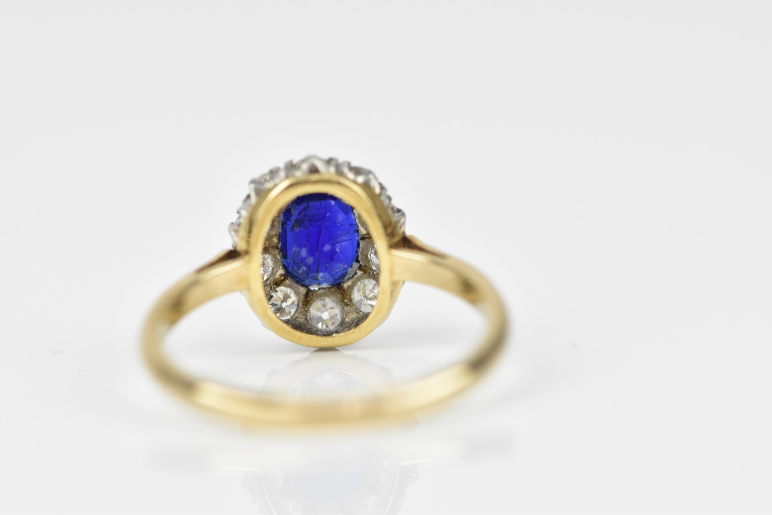 An 18ct yellow gold, sapphire and diamond cluster ring, with central oval cut blue sapphire in a - Image 4 of 6
