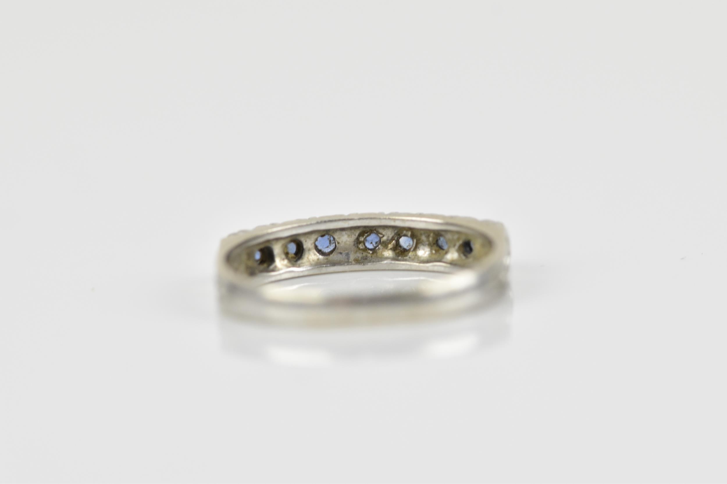 A 9ct white gold and blue sapphire half eternity ring, set with a row of seven same-sized pave-set - Image 5 of 7