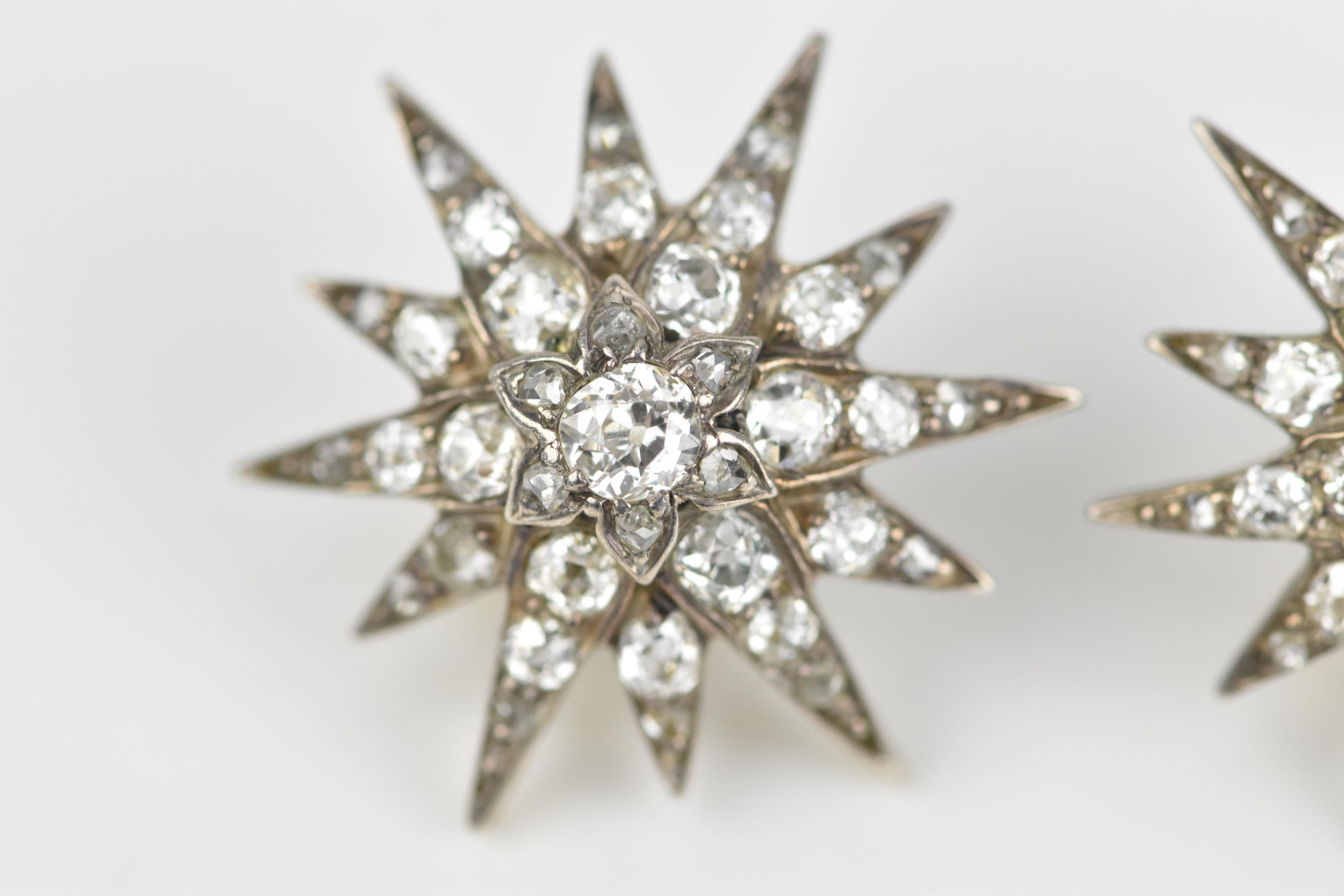 A pair of early 20th century white metal and diamond starburst earrings, set with old mine cut - Image 3 of 9