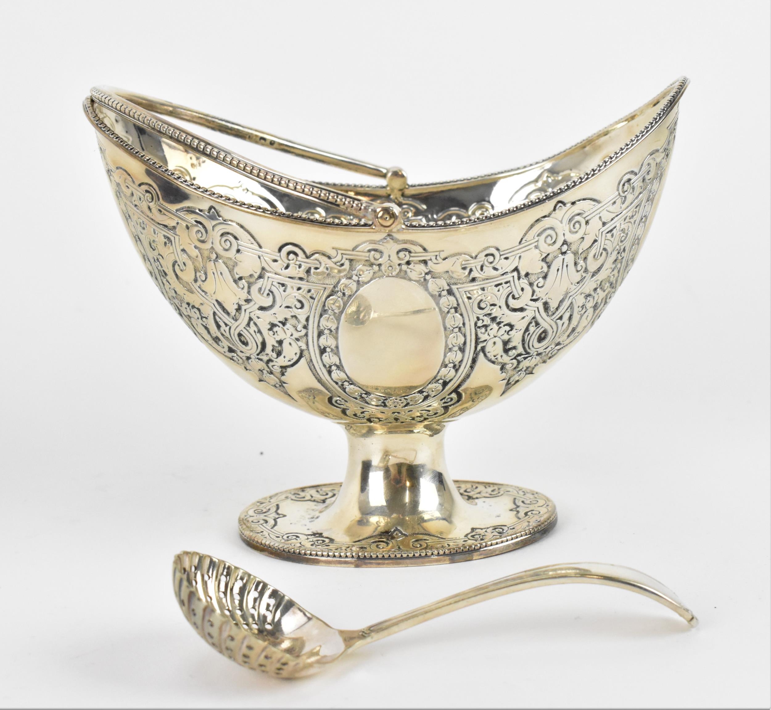 A cased Victorian silver sugar basket, London 1880, of oval form with swing handle, beaded rim and - Image 2 of 8