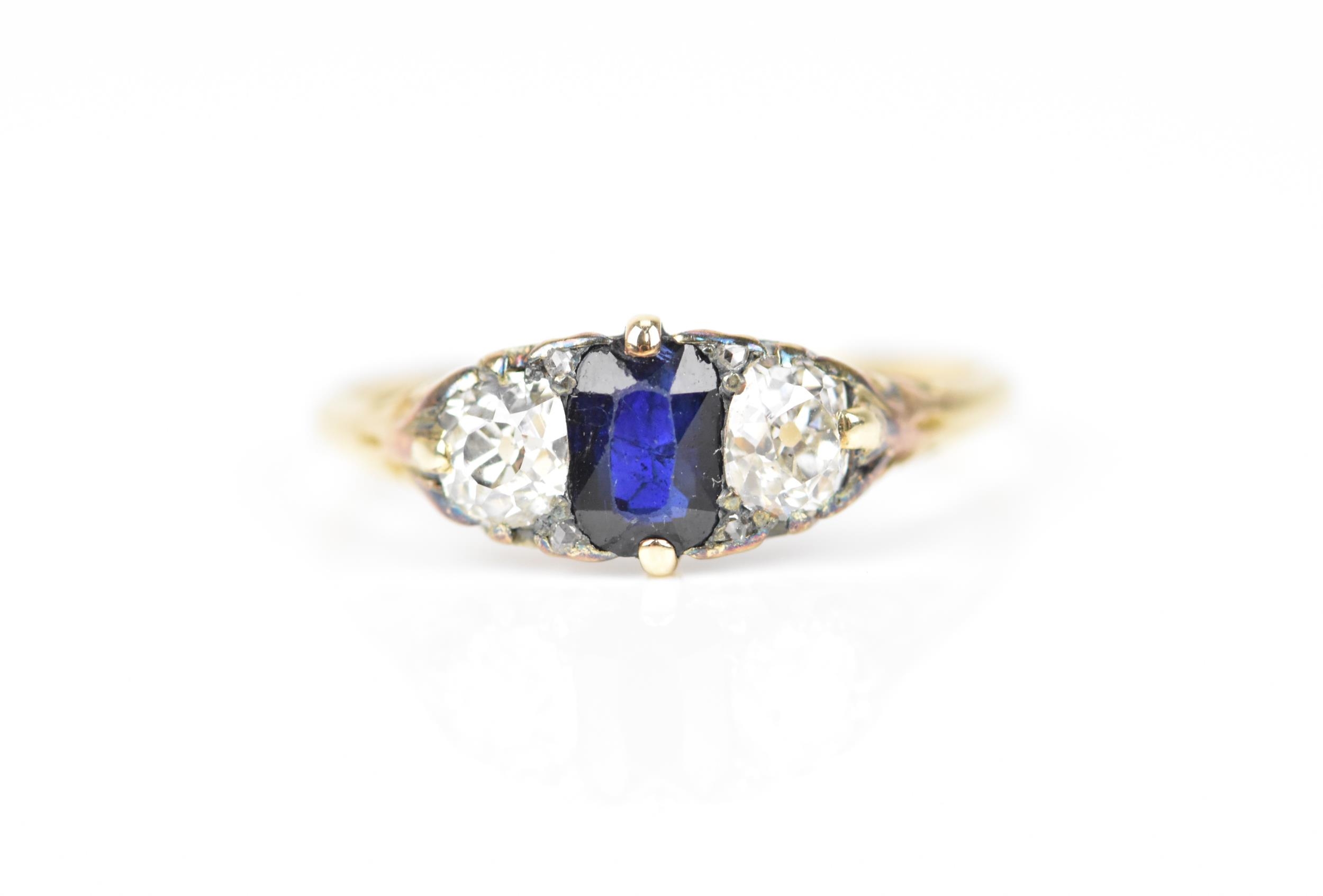 A yellow metal, blue sapphire and diamond dress ring, with central octagon cut sapphire flanked with - Image 2 of 6