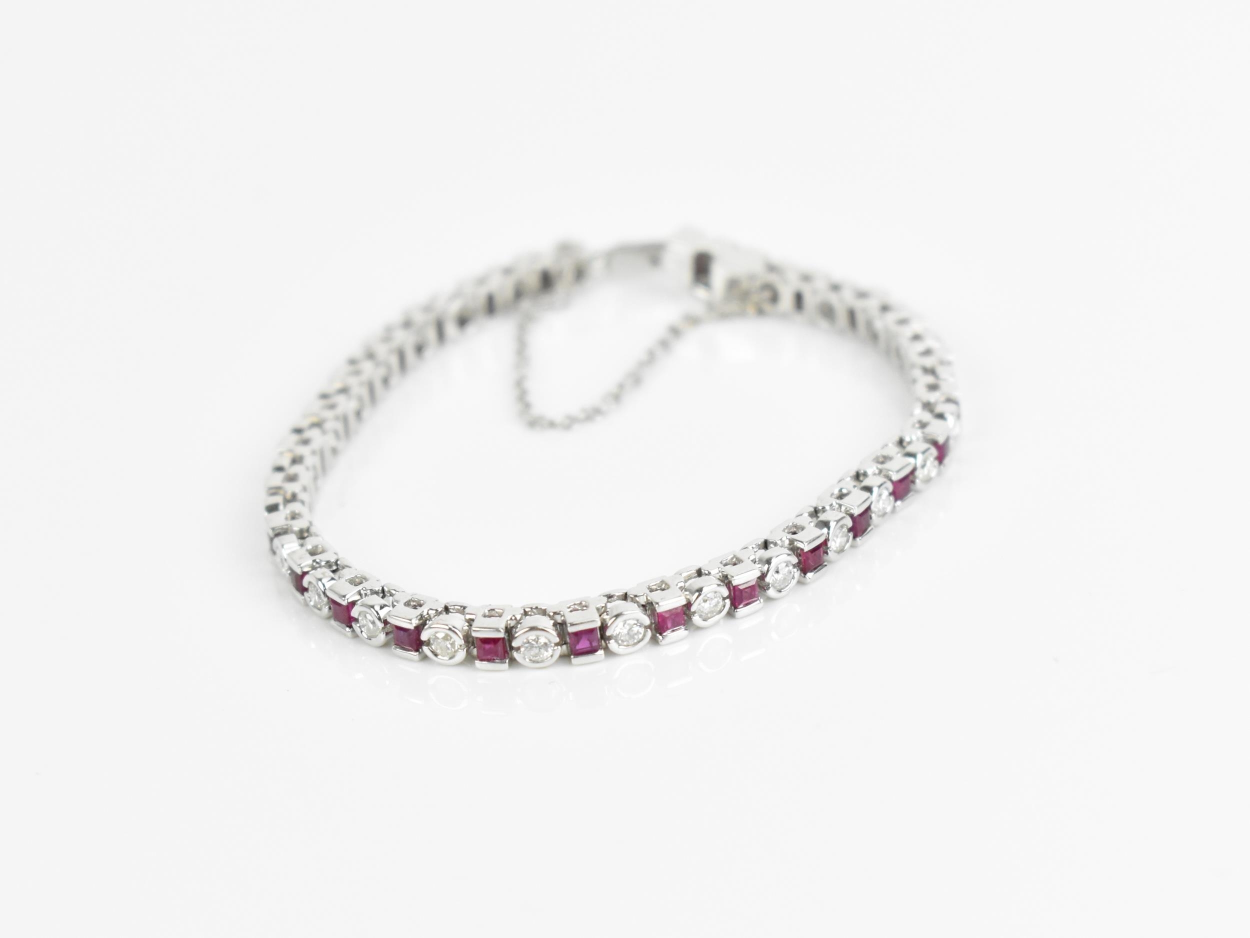 An 18ct white gold, diamond and ruby bracelet, with alternating round brilliant cut diamond and - Image 8 of 8