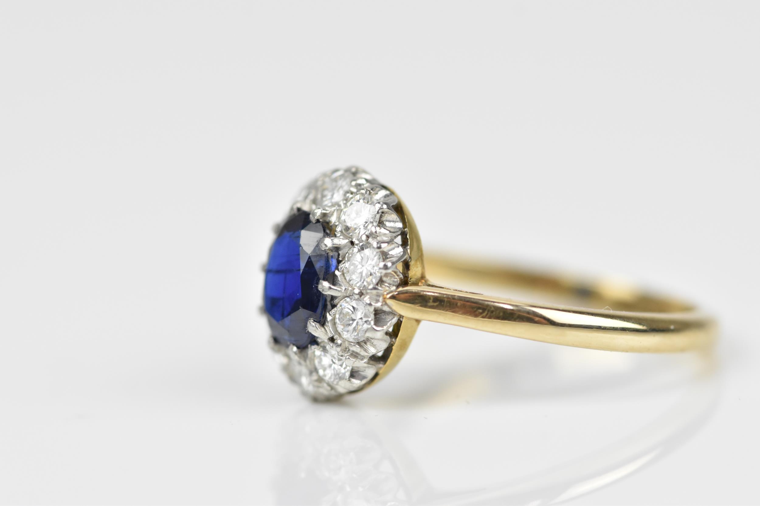 An 18ct yellow gold, sapphire and diamond cluster ring, with central oval cut blue sapphire in a - Image 3 of 6