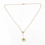 An early 20th century 9ct yellow gold and peridot necklace, the cable link chain with central