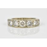 An 18ct gold and diamond seven stone ring, inset with graduated diamonds, the central one approx.