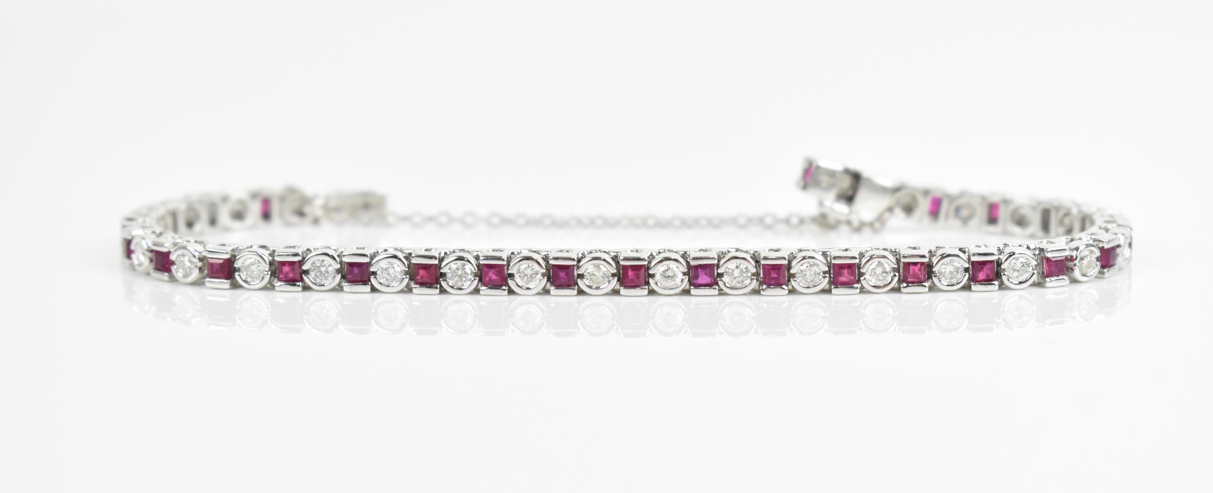 An 18ct white gold, diamond and ruby bracelet, with alternating round brilliant cut diamond and