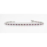 An 18ct white gold, diamond and ruby bracelet, with alternating round brilliant cut diamond and