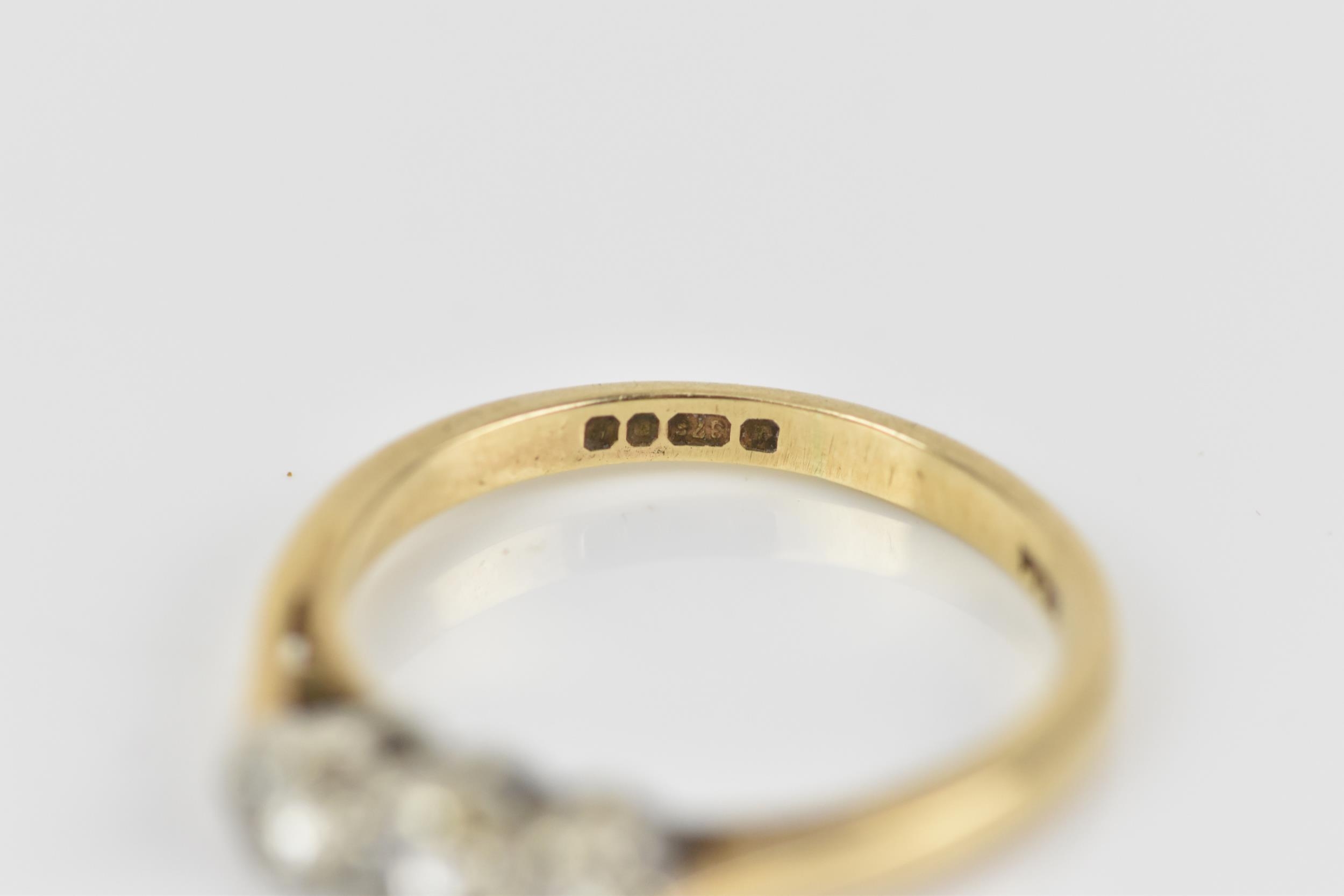 A 9ct yellow gold and three stone diamond ring, all three brilliant stones set in white metal with - Image 3 of 5