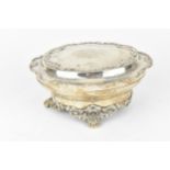 An Edwardian silver lidded box, London 1903, with moulded border, the hinged lid with etched