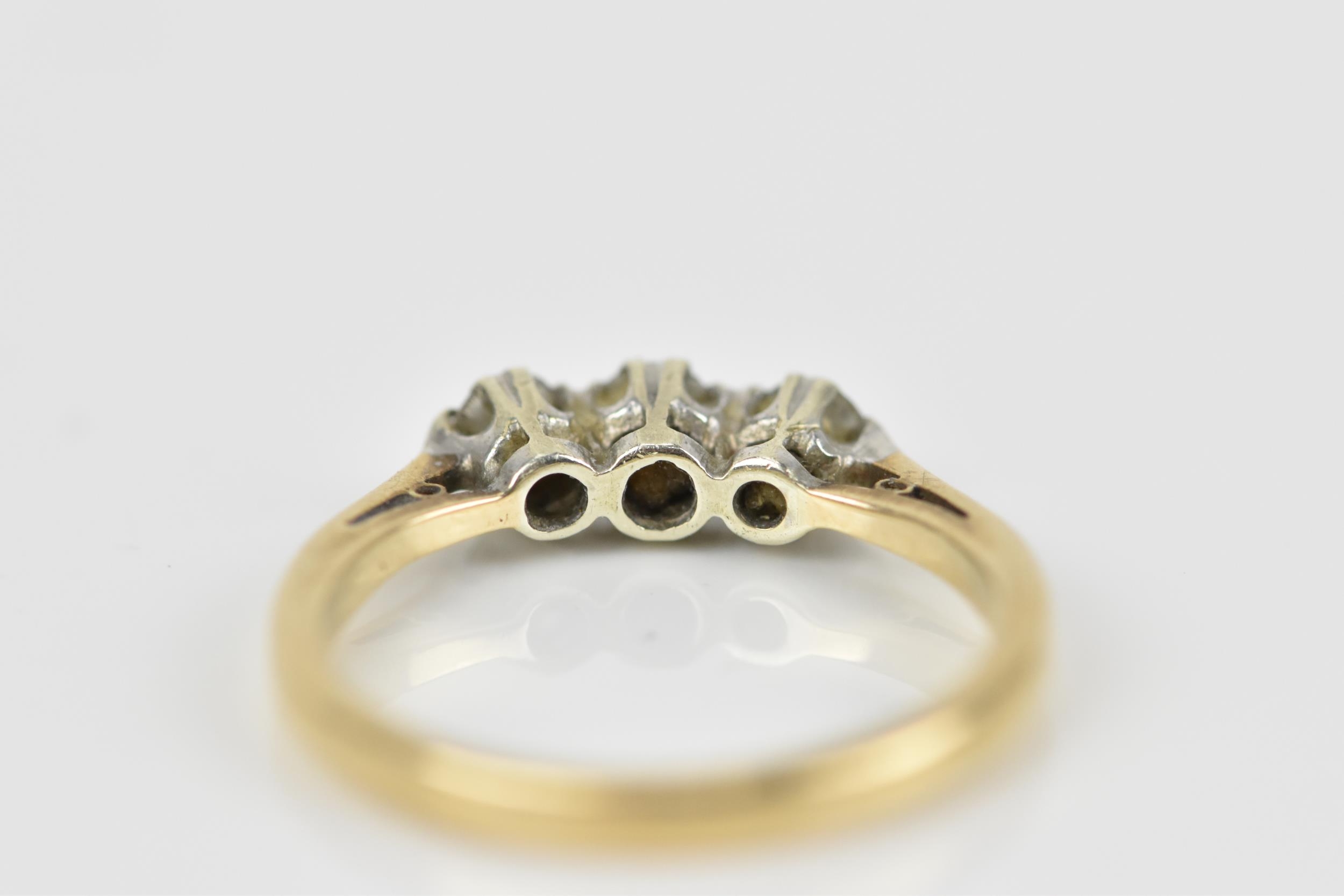 A 9ct yellow gold and three stone diamond ring, all three brilliant stones set in white metal with - Image 5 of 5