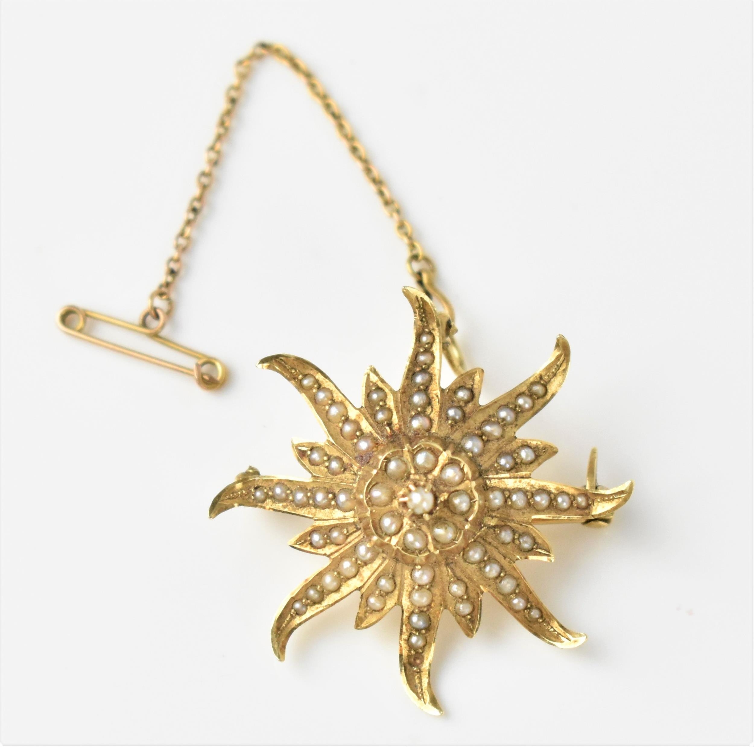 A 14ct yellow gold and seed pearl starburst brooch, inset with graduated seed pearls, stamped 14k,