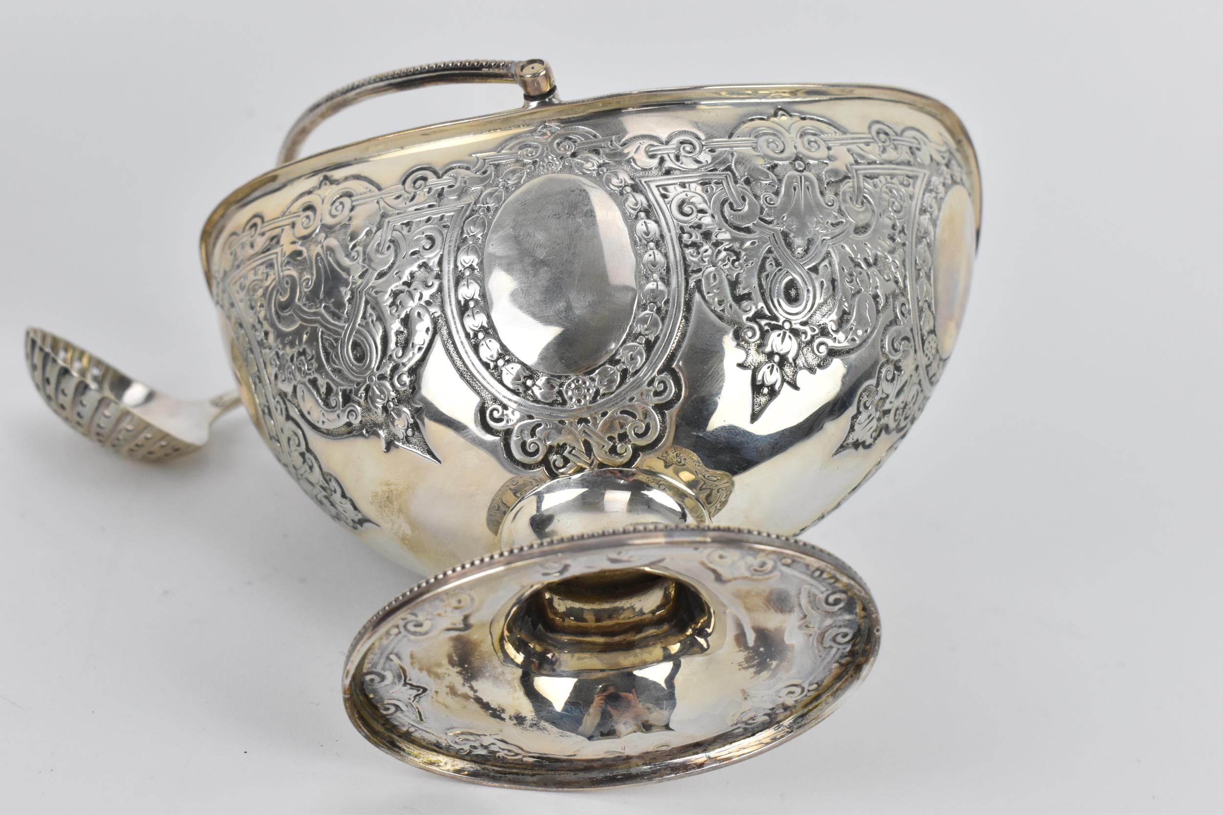 A cased Victorian silver sugar basket, London 1880, of oval form with swing handle, beaded rim and - Image 6 of 8