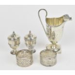 A small collection of silver, to include an Edwardian silver milk jug, a pair of Victorian pepper