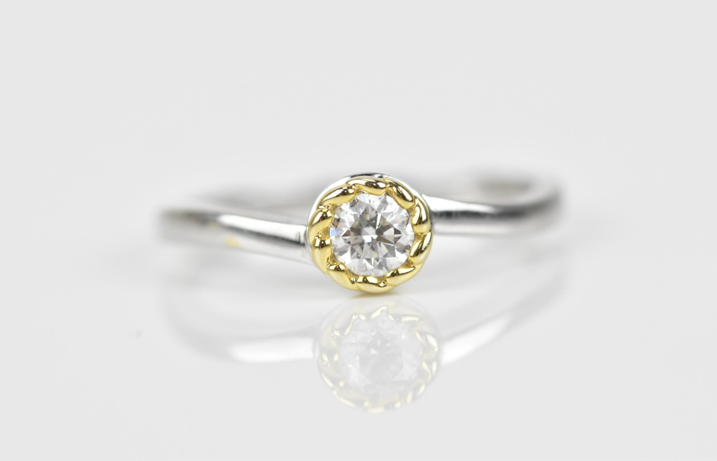 An 18ct white gold and diamond solitaire ring, the round brilliant cut stone approx 0.25 ct, size M