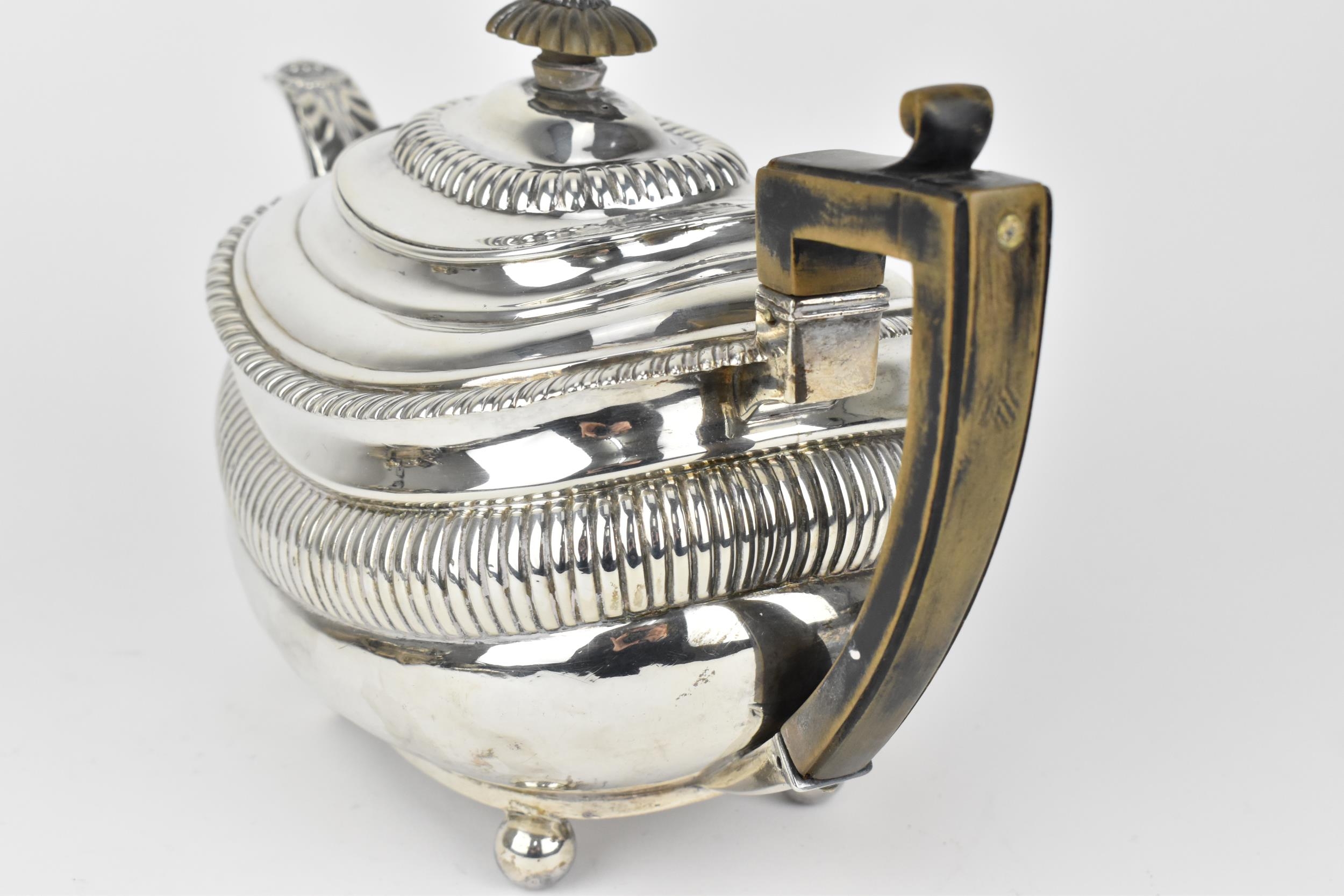 A George III silver teapot, London 1819, with gadrooned rim and wooden final and handle, the spout - Image 5 of 7