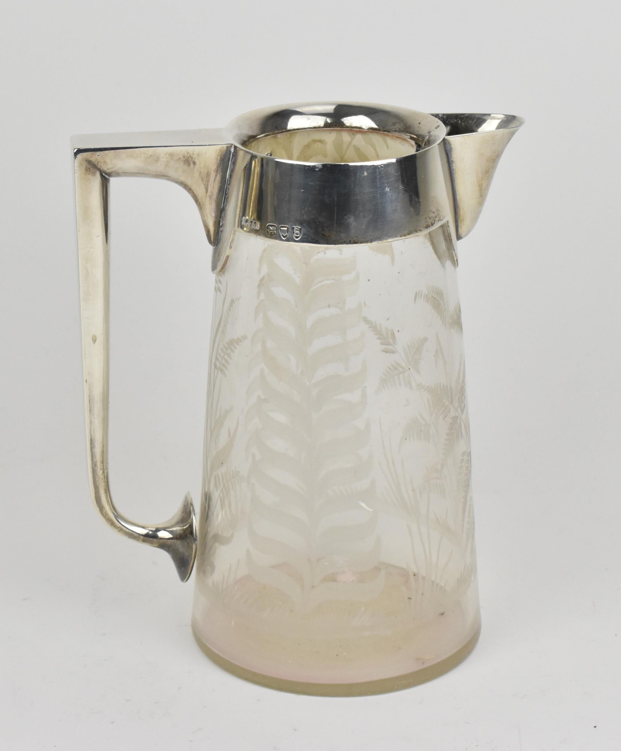 A Victorian silver mounted glass jug by John Grinsell & Sons, London 1893, of tapered form with