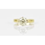 An 18ct yellow gold, white metal and solitaire diamond ring, the brilliant cut stone in an eight