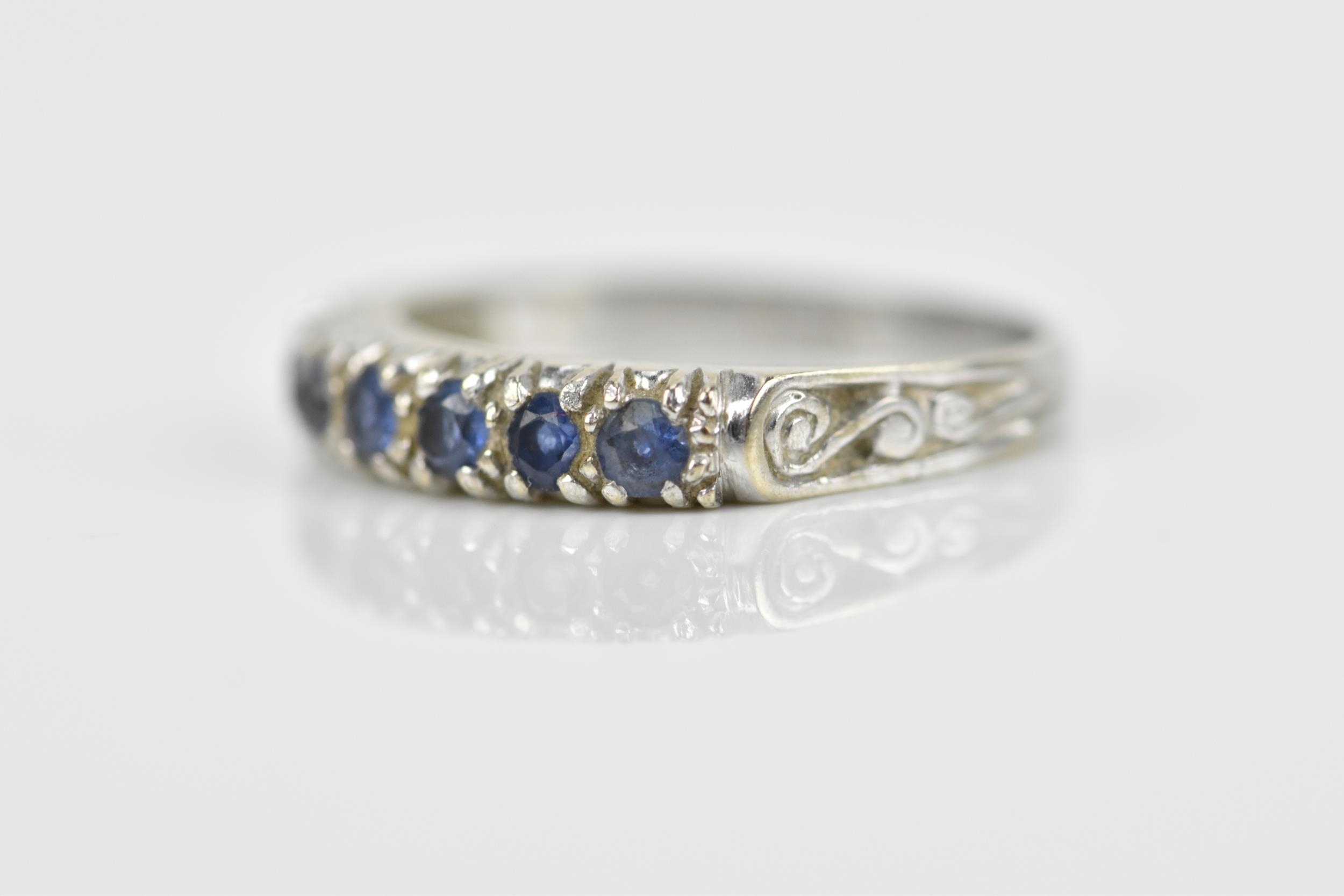 A 9ct white gold and blue sapphire half eternity ring, set with a row of seven same-sized pave-set - Image 3 of 7