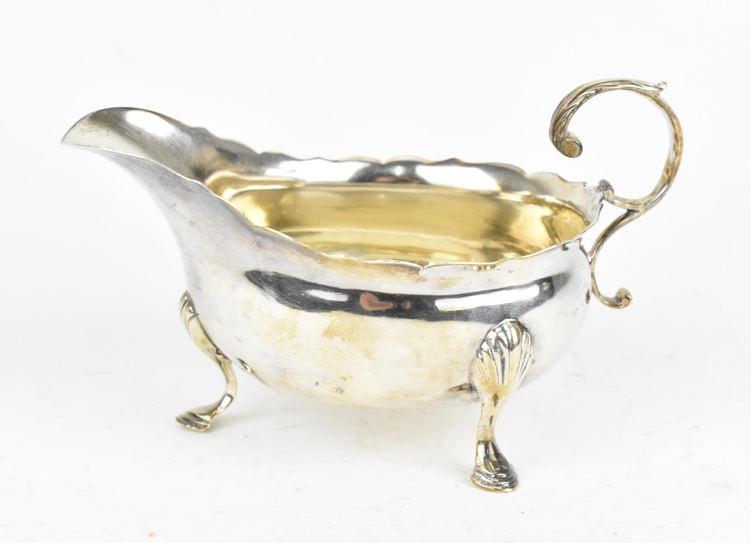 A George III small silver sauce boat by David Hennell I & Robert Hennell I, London 1765, with ogee